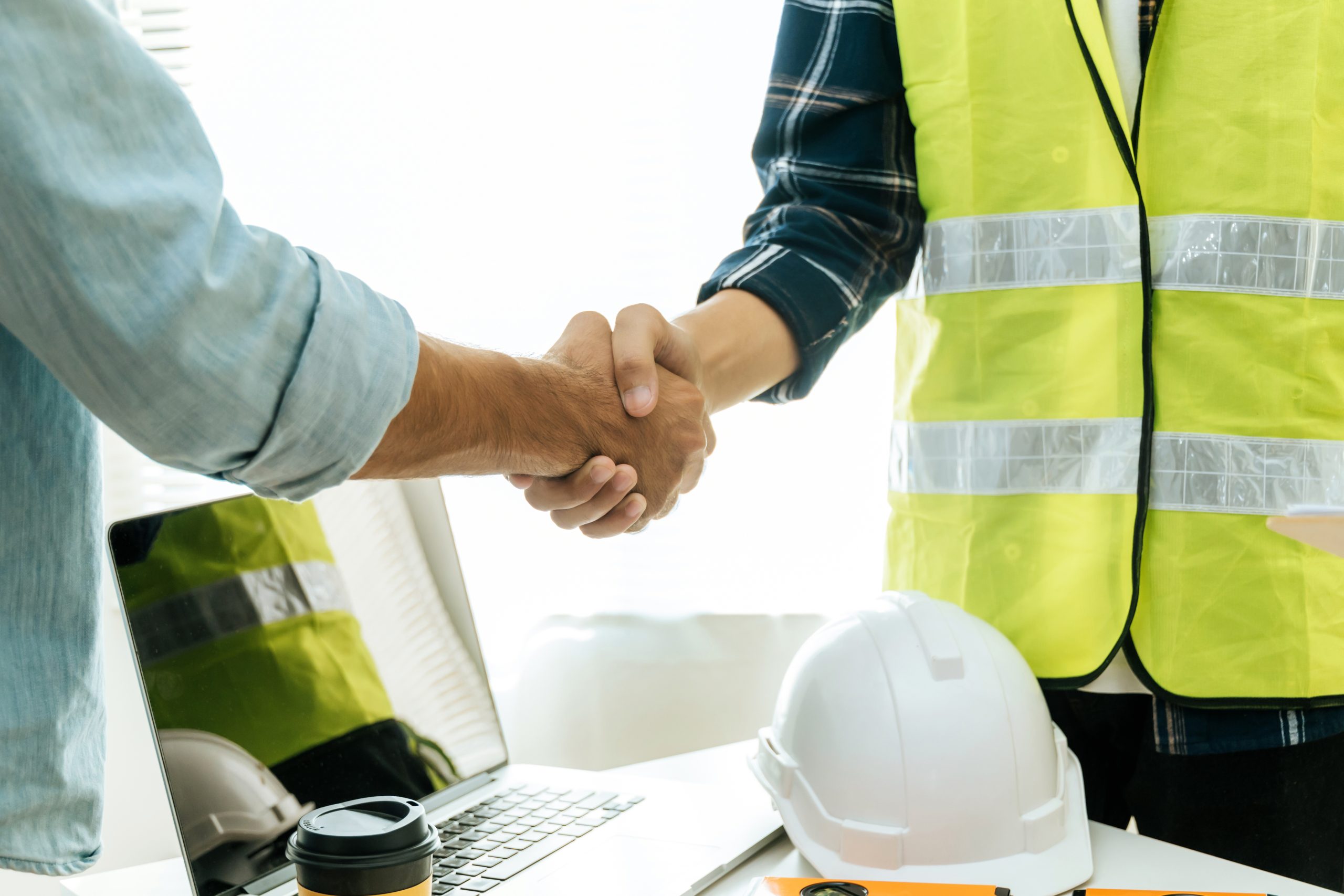 engineer, architect, construction worker team hands shaking afte
