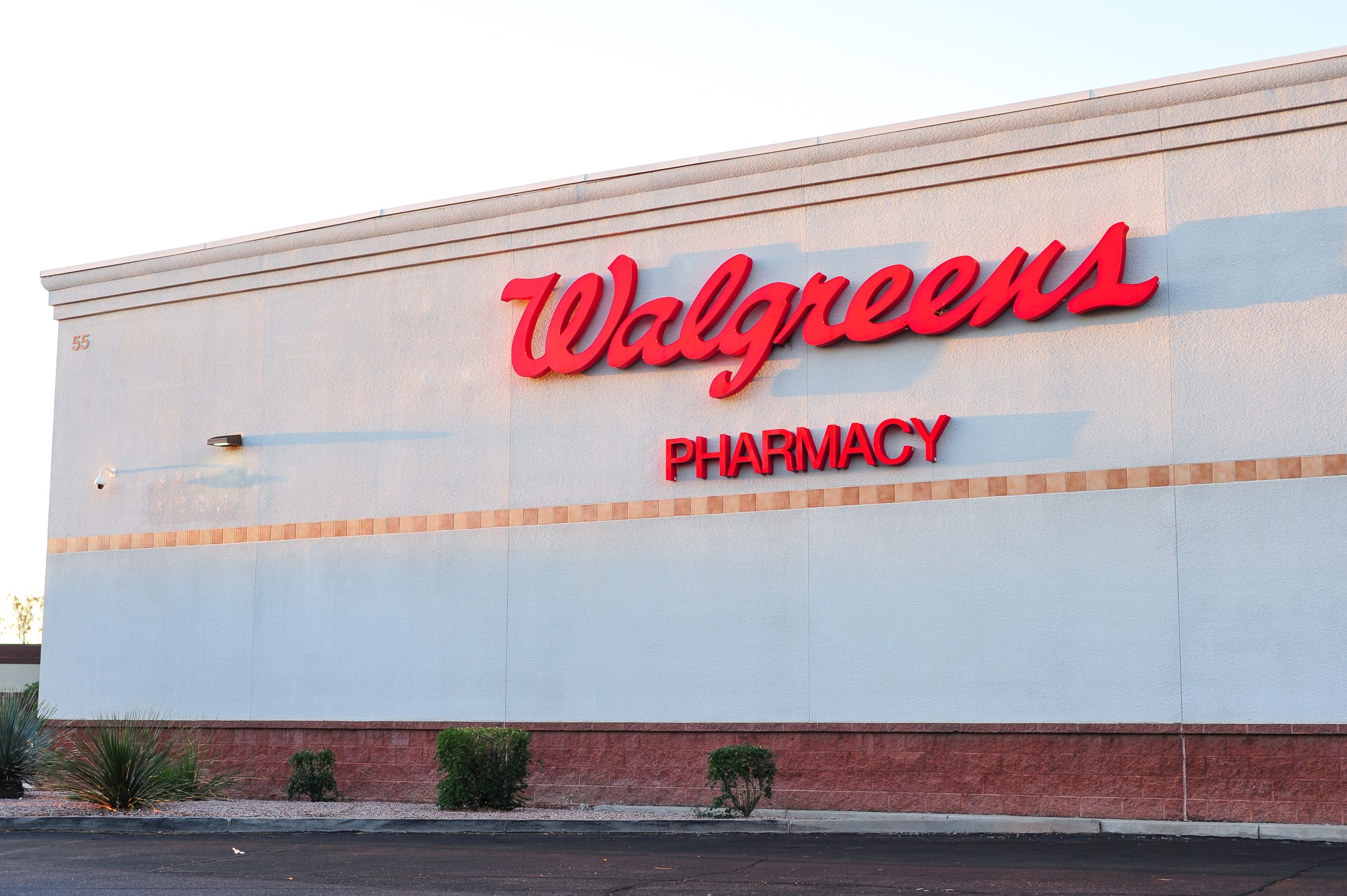 A side view of a Walgreens Pharmacy building showing brand logo